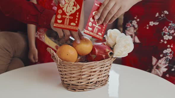 Chinese Family Making Gift Basket for Lunar New Year alt