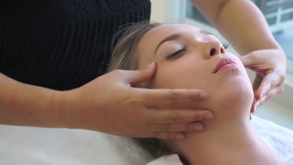 Woman Gets Facial and Head Massage in Luxury Spa alt