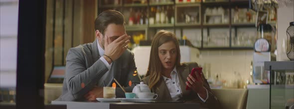 Woman showing mobile phone display alt
