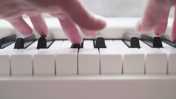 Fingers Play on White Piano