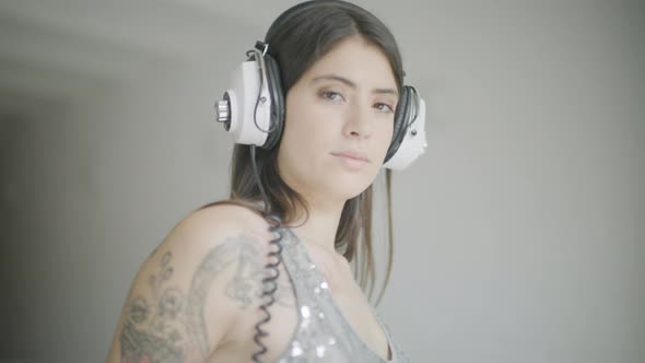 Female Dancer with Headphones Indoors alt