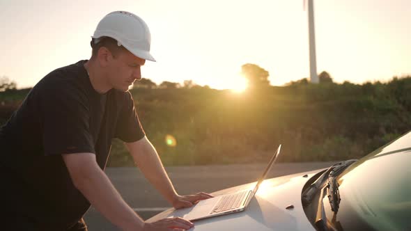 Technician Engineer Working at Wind Turbine Using Laptop Computer Worker or Operator Checks Wind alt