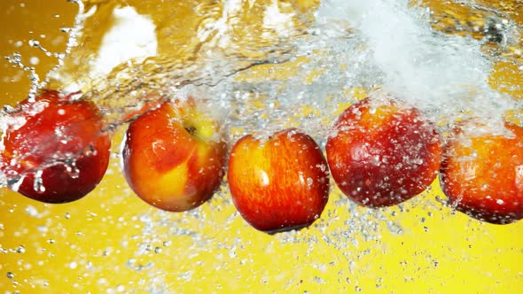 Super Slow Motion Shot of Flying Fresh Peach and Water Side Splash at 1000Fps. alt