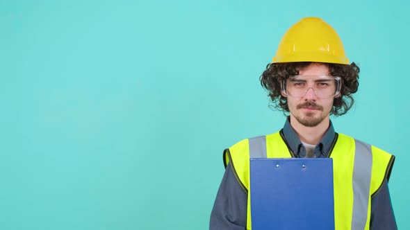 Construction Worker with Safety Glasses and Helmet That is Looking at Camera Smile alt
