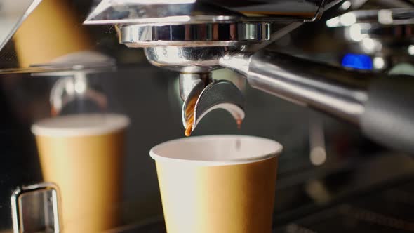 Extraction of Espresso Coffee From the Double Holder of the Coffee Machine Into a Disposable Paper alt