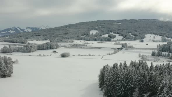 Aerial of beautiful snow covered landscape in Vaud, Switzerland alt