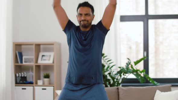 Indian Man Doing Jumping Jack Exercise at Home alt