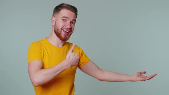 Man Pointing Empty Place Advertising Area for Commercial Text Copy Space for Goods Promotion alt