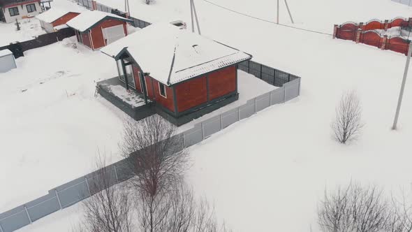 Modern Cottage in Countryside in Winter Aerial View alt