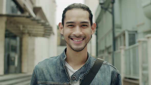 Portrait of a smiling handsome young Asian man.