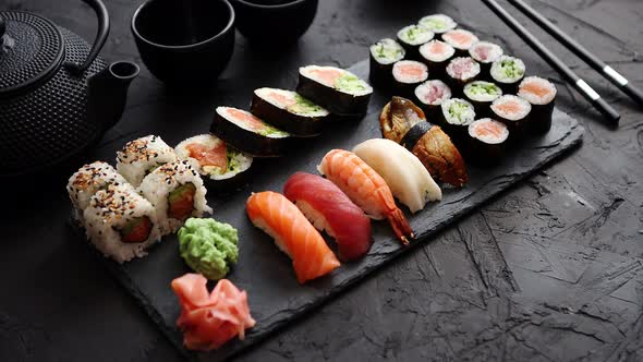 Sushi Rolls Set with Salmon and Tuna Fish Served on Black Stone Board alt