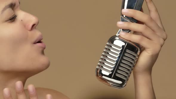 Beauty Portrait of Young African American Woman Singing Song Into Vintage Retro Microphone, Stock Footage