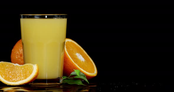 A Glass of Orange Juice Slowly Rotates.  alt