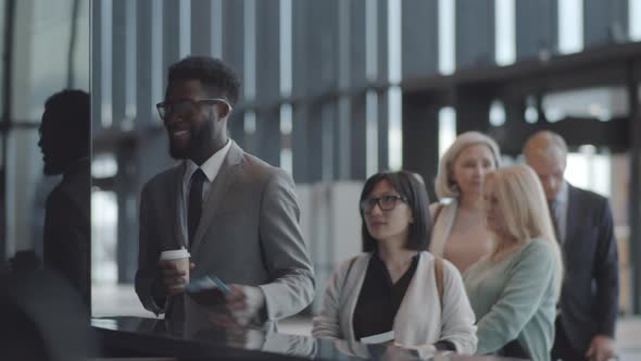 Smiling Multiethnic Passengers Checking in for Flight at International Airport alt