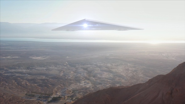 Large Triangle alien ufo over sea and desert mountains-Aerial alt