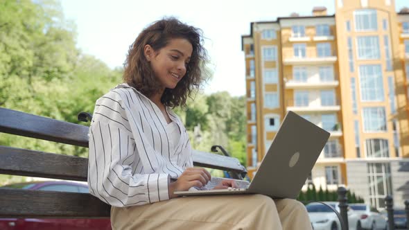 Young Beautiful Hispanic Girl Making a Video Call Using a Laptop alt