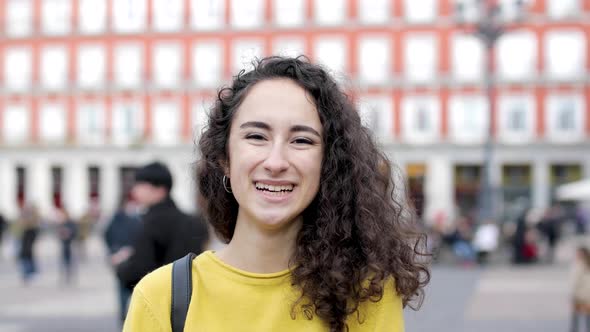 Portrait of a beautiful girl young woman in Madrid looking at camera and smil