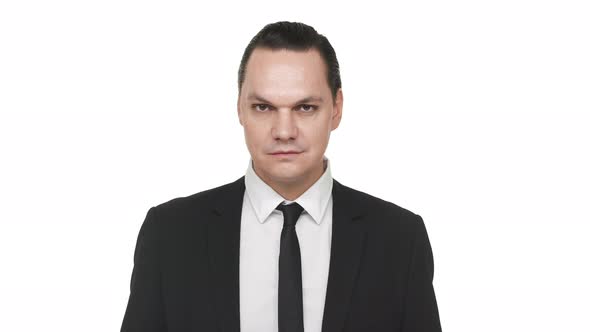 Portrait of Uptight Handsome Man in Classic Suit Posing Over White Background in Studio with Heavy alt