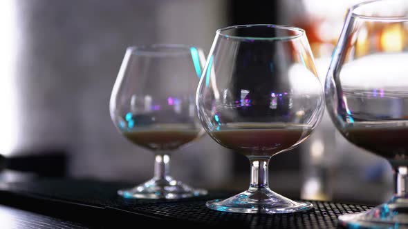 Glasses with a Cocktail at the Bar Counter alt
