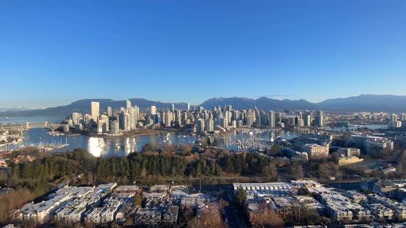 Aerial Timelapse of Vancouver Canada city skyline during sunny day with clear sky. time lapse of big alt