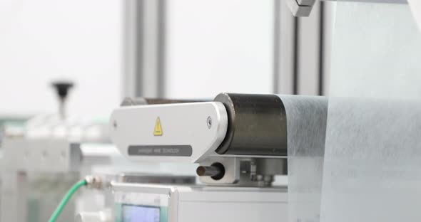 Non-woven Fabric Filter Layer Of Surgical Mask Rolling On Position Roller At Mask Making Machine. - alt