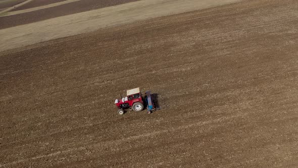 Combine Plowing Agricultural Field in the Spring alt