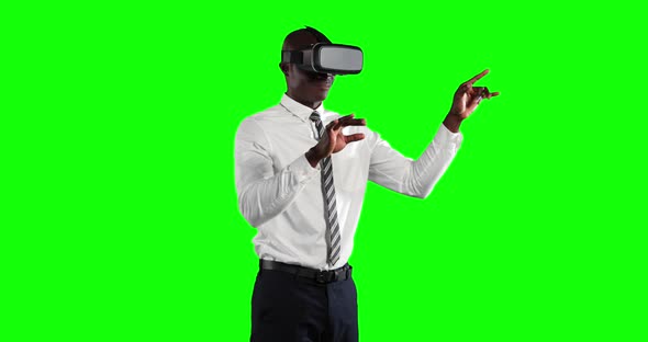 an African American man wearing 3D goggles in a green background