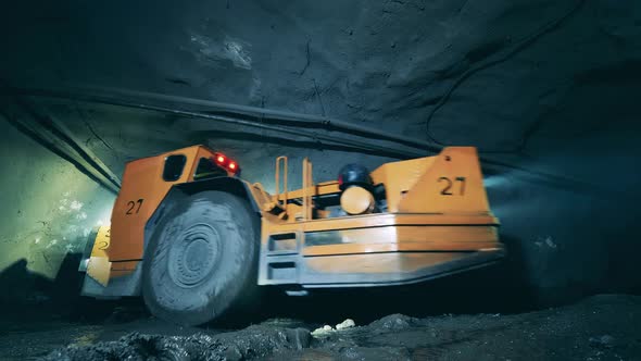 Underground Tunnel with an Industrial Machine Driving Through It alt