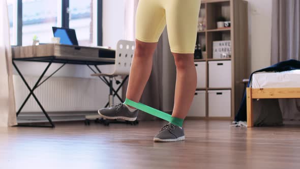 Woman Exercising with Resistance Band at Home
