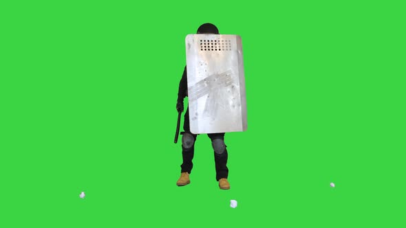 Trash Is Thrown Into Special Unit Policeman with the Shield Up on a Green Screen Chroma Key alt