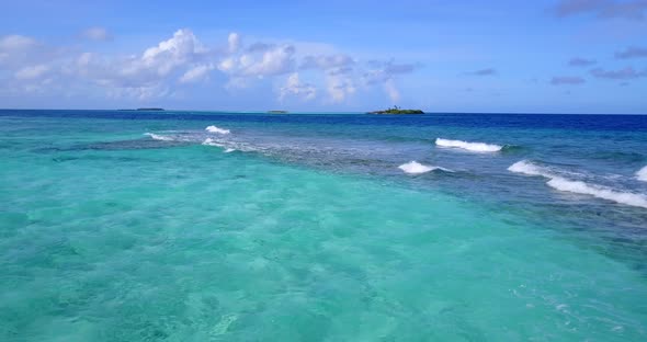 Wide angle overhead copy space shot of a white paradise beach and blue ocean background in vibrant 4 alt