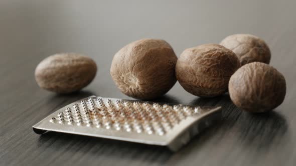 Myristica fragrans collection and mini grater slow pan 4K 2160p 30fps UltraHD footage - Spice fruit  alt