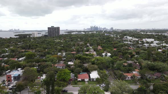 Aerial of suburban Miami with downtown Miami, Florida visible in the distane.  An aerial railcam vid alt