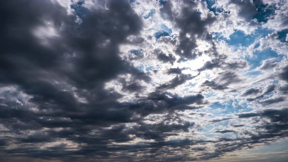 Dramatic Cumulus Cirrus Clouds Move in the Blue Sky. Sunbeams Shine. Time Lapse alt