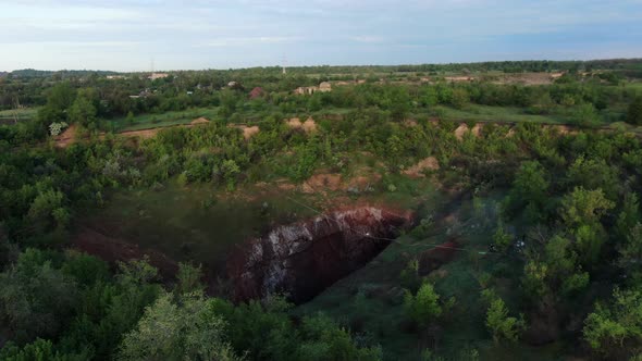 Stunning Aerial View on the Nature and a Huge Pit with a Slackline Stretched alt