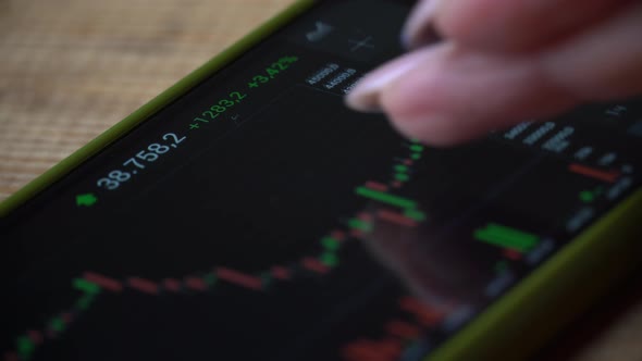 Stock Exchange Online Trading Trader Girl Working with a Smartphone on the Stock Market Trading alt