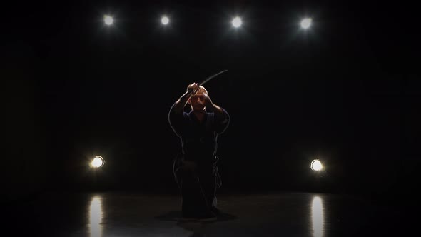 Masculine Kendo Fighter Practicing Martial Art with the Katana Sword. alt
