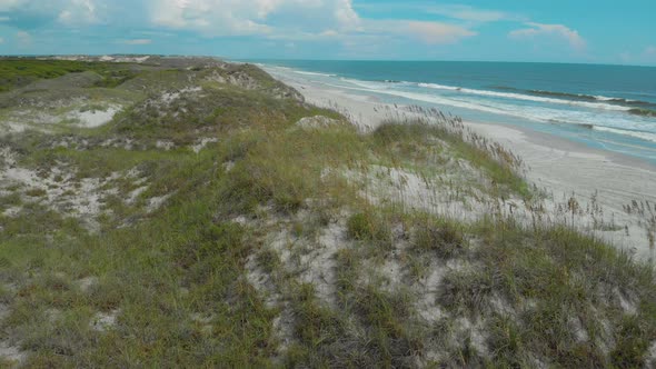 drone shots of the sand dunes and marsh lands at the coast alt