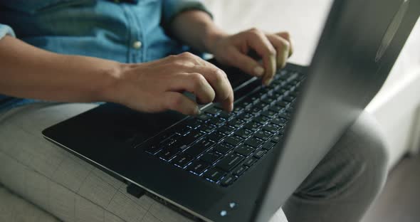 Woman Texting on Laptop