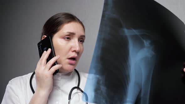 Orthopedist Reports Results of Xray Examination on Phone alt