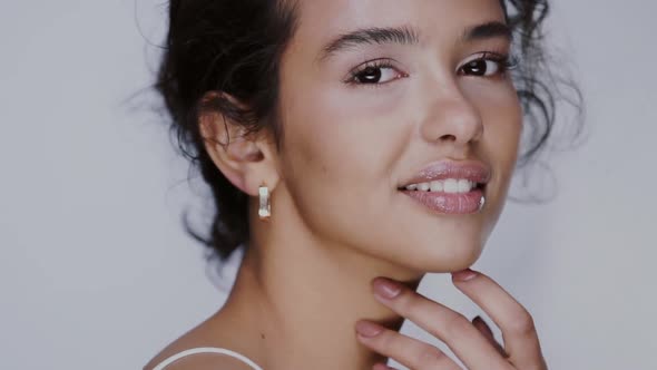 Cute Girl with Naked Shoulders Looking at Camera and Smiling, Model with Light Nude Make-up, Gray alt