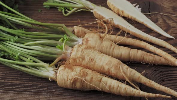 Heap roots parsley with leaves on wooden background 