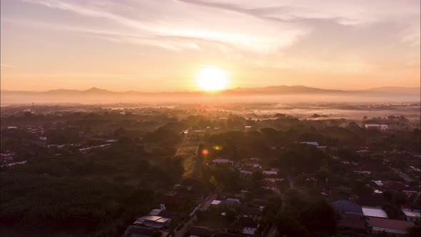 Hyperlapse drone lapse of sunrise above asia village in morning alt