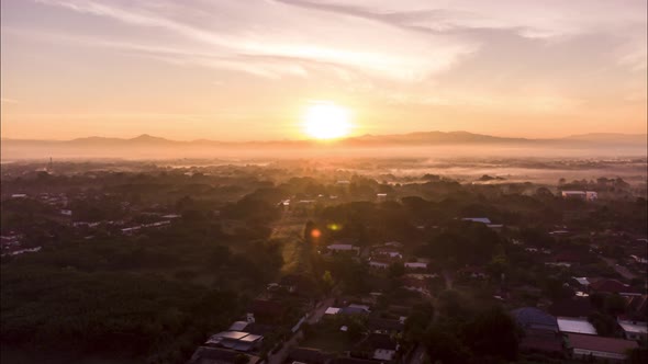 Hyperlapse drone lapse of sunrise above asia village in morning
