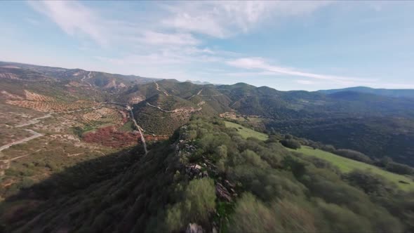 Aerial View Flying Fast Down Beautiful Lush Mountain Range Ridge. HD FPV Drone. alt