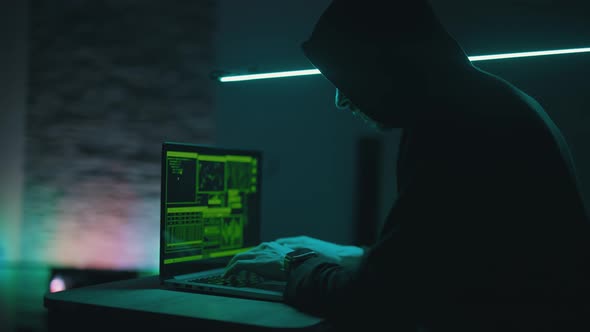 Hacker is Working on Laptop at Night alt