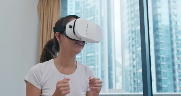 Woman Play Boxing Game and Wearing VR Device alt