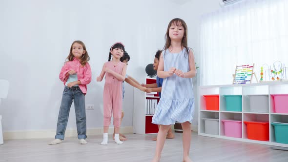 Mixed race Group of young children student playing together in school. alt