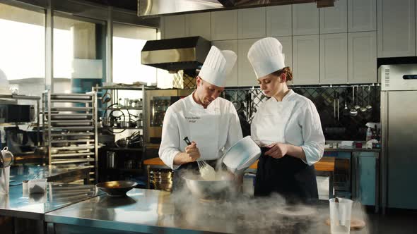 Professional kitchen: liquid nitrogen is added during the cooking of a molecular dish alt