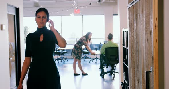 Businesswoman talking on mobile phone in a modern office 4k